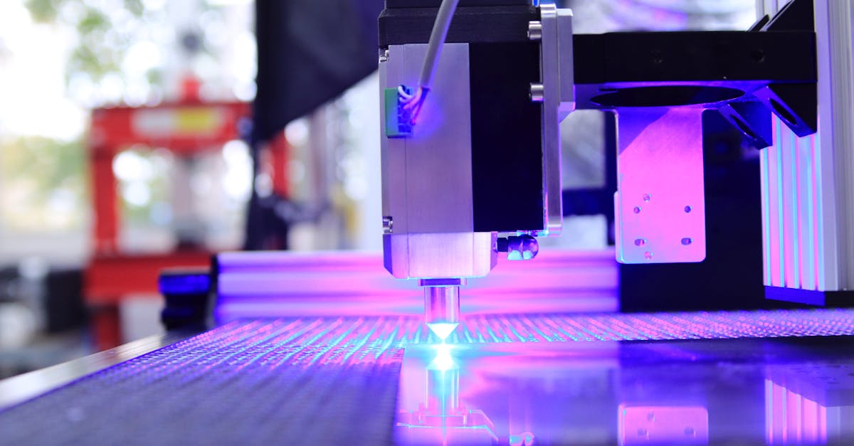 close up of a laser engraving machine working indoors with blue light reflection
