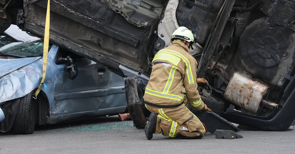 firefighter in gear assisting at an overturned car crash scene ensuring safety during the rescue op