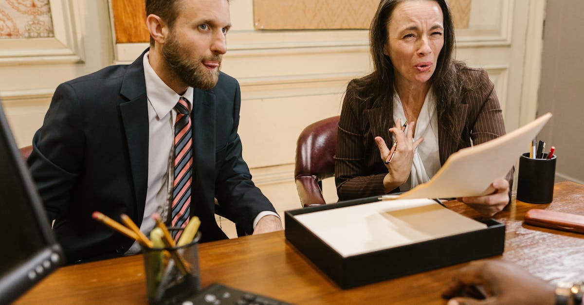 lawyers discussing legal documents in a professional office setting